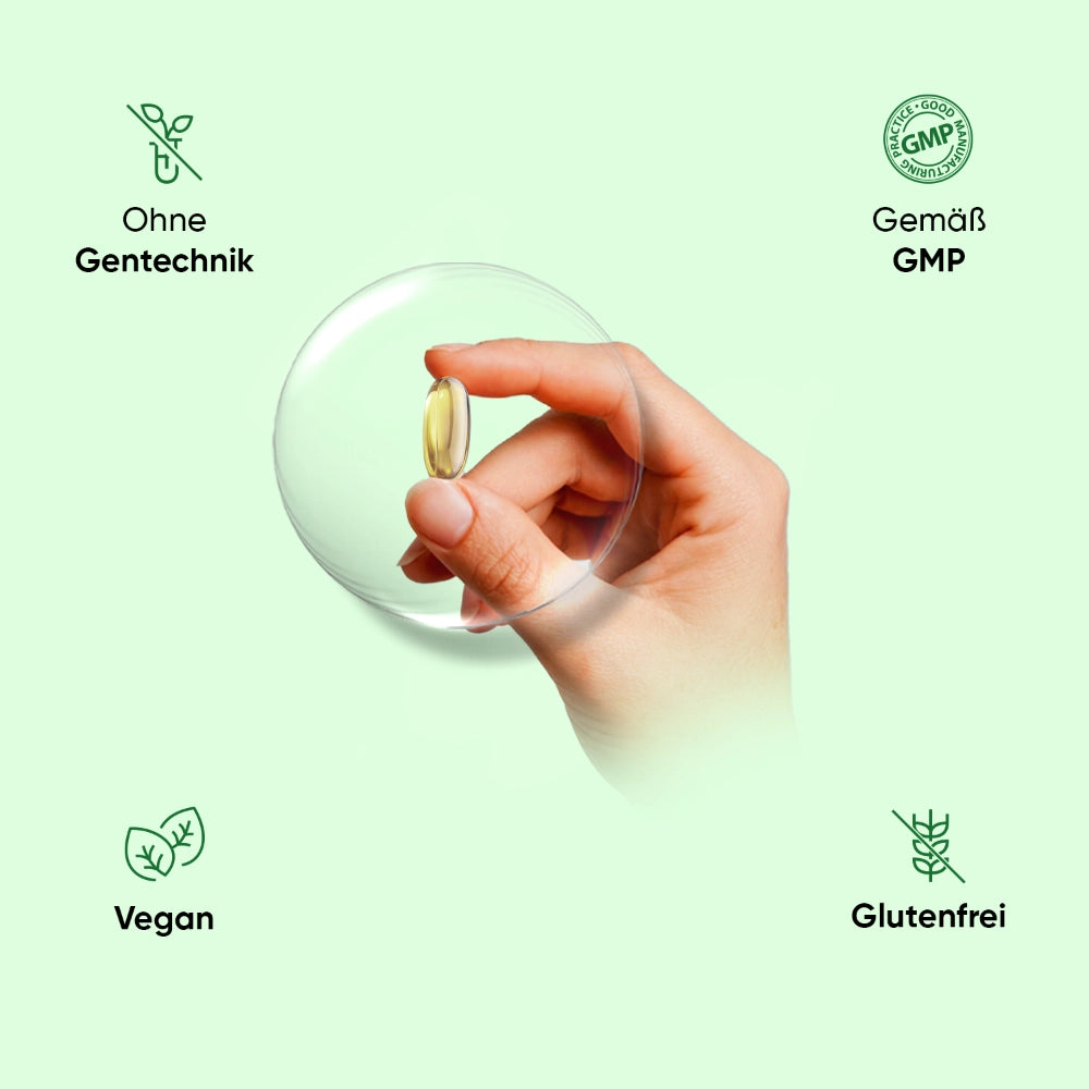 Vegane Omega-3 Kapsel in Hand, transparente Kugel mit goldener Kapsel