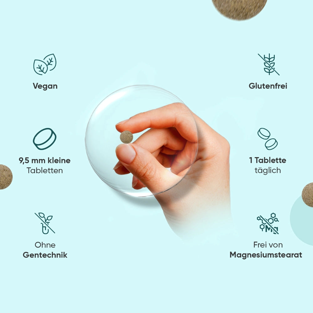 Hand hält kleine Tablette; Icons für vegan, glutenfrei und ohne Gentechnik